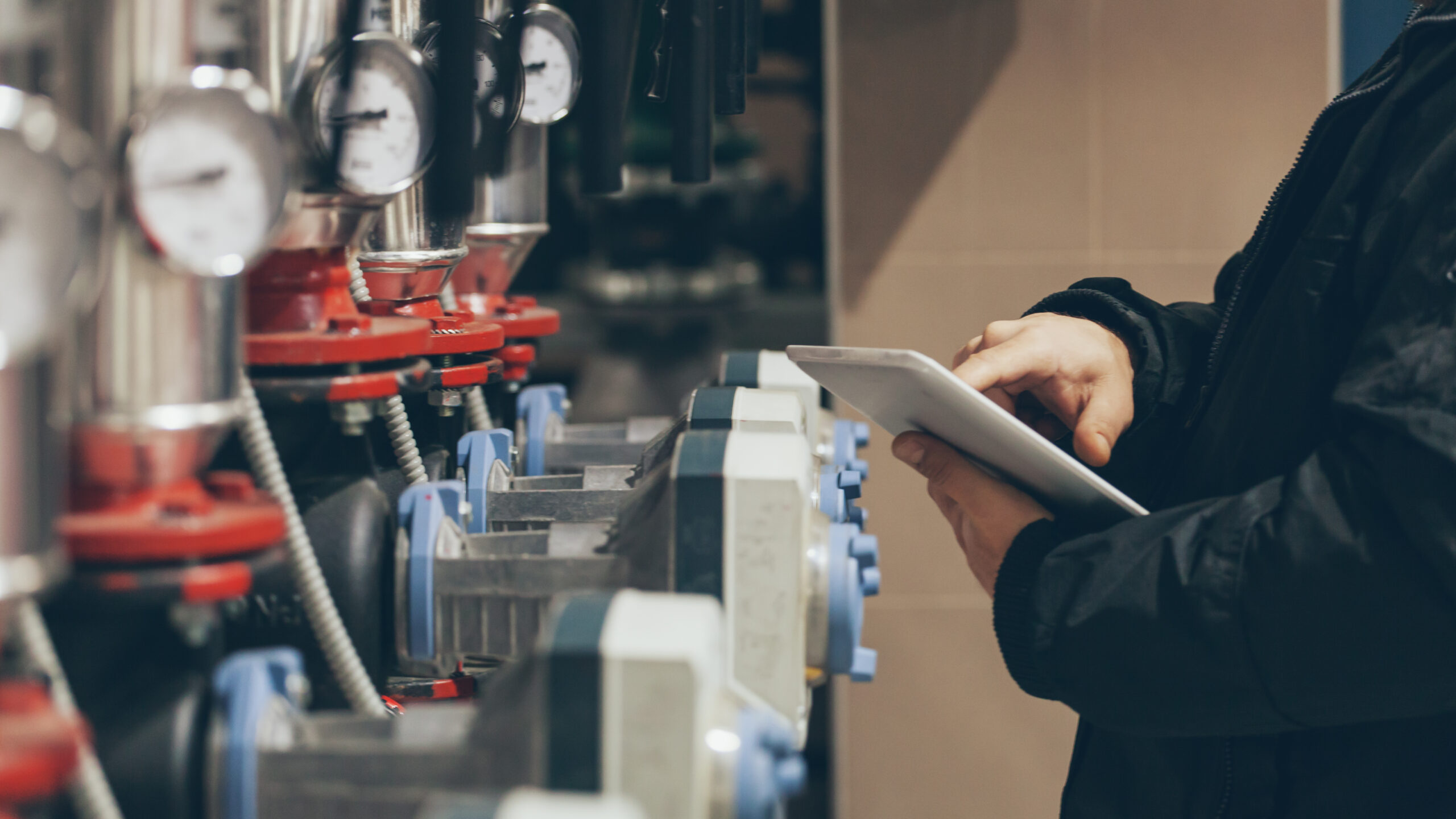 maintenance technician performing a facility inspection on boiler equipment